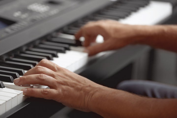 Fototapeta na wymiar Male hands playing on synthesizer