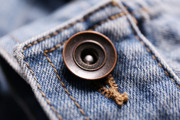 Button on a denim cloth close up