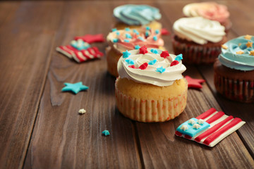 Delicious cupcakes on wooden background