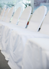 chairs with white fabric cover for celebrations