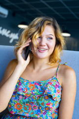 Fototapeta premium Joyful woman talking on mobile phone