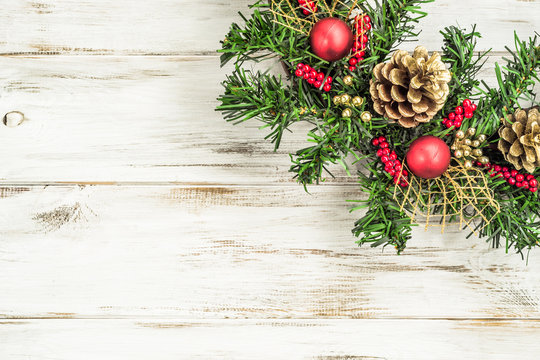 Ornamental Christmas Garland on shabby white wooden door background
