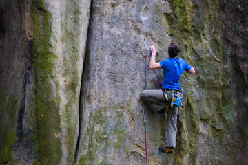 A rock climber climbs up the mountain.