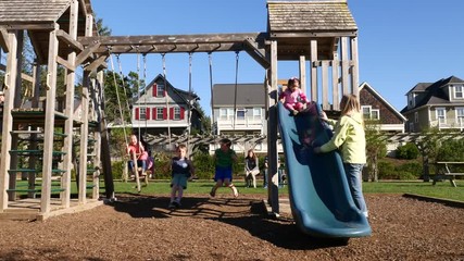 Family playing at park playground