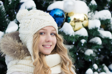 portrait of girl in winter. Fur hood, warm white mittens.