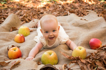 Fototapeta na wymiar Cute baby girl with apples