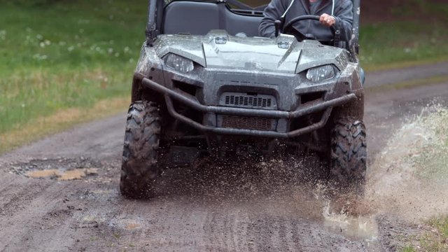 Closeup of atv going through mud in slow motion