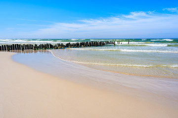 Breakwaters on sandy beach in Debki village, Baltic Sea, Poland