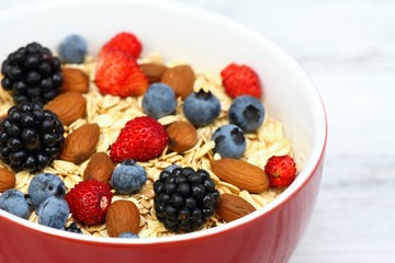Breakfast oatmeal with wild strawberries, blueberries, blackberries & almonds   for breakfast
