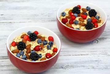 Breakfast oatmeal with wild strawberries, blueberries, blackberries & almonds