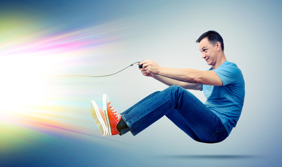 Funny man with joystick playing computer game, gamer concept © afxhome