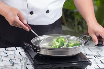 Chef scald broccoli with hot water