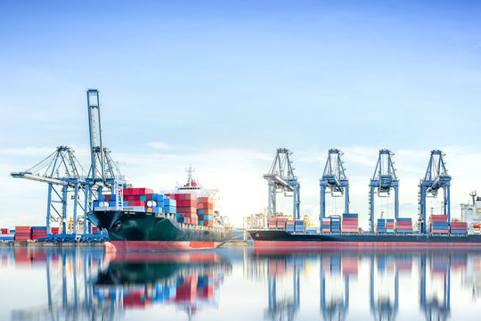 International Container Cargo ship with working crane bridge in