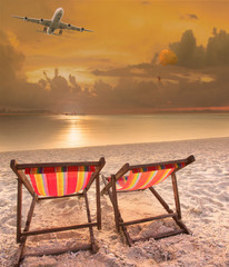 beach chairs at sea beach and passenger plane flying above