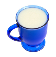 Mug of buttermilk on a white background