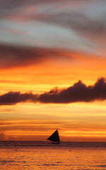 Sailboat under a fiery Boracay Island sunset