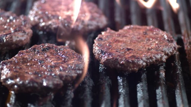 Hamburgers on grill in slow motion, shot on Phantom Flex 4K