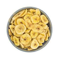 Dried bananas in an old bowl on white background.