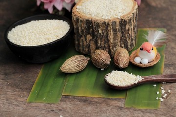 White sesame seeds organic on wood background.
