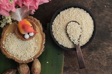 White sesame seeds organic on wood background.