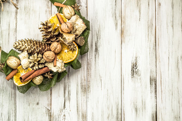 Christmas wreath with dried fruits on wooden door