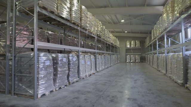 Large furniture warehouse. Mezzanine shelving with large packages of food ready for dispatch. Warehouse wholesaler.