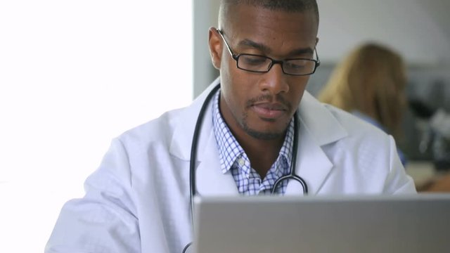 Doctor looking at x-ray in office