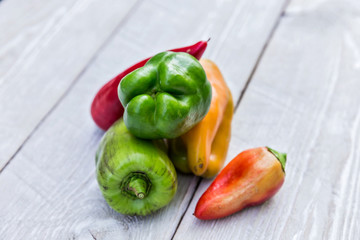 colored peppers on a a wooden background
