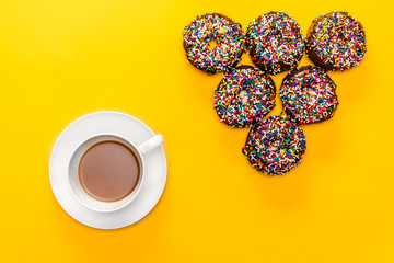 A delicious cup of hot coffee creating an arrow with half a dozen donuts to point at whatever you would like advertised or highlighted.