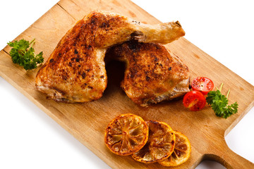 Roast chicken legs on cutting board
