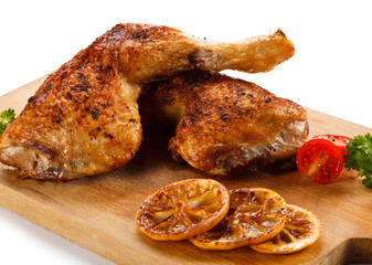Roast chicken legs on cutting board