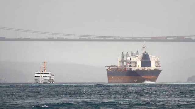 Cargo ship sailing out the harbor in winter. Sea Transportation
