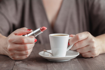 Woman holding cup of espresso