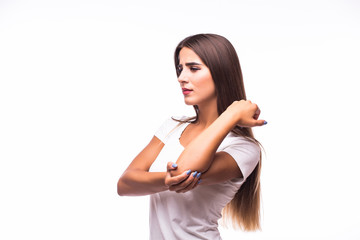 Acute pain in a woman elbow. Female is holding hand to spot of elbow pain indicating location of the pain. Isolation on a white background.