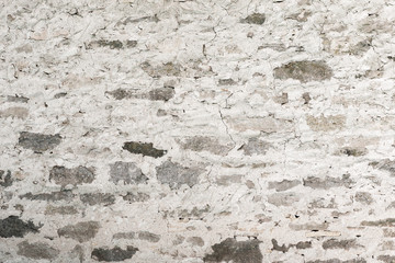 Old plastered stone wall in white