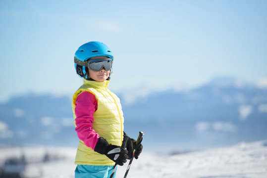 Portrait of a smiling skier girl on a sunny day  in the mountain