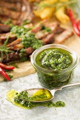 Green chimichurri sauce with grilled steak