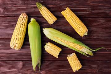 Top view of ripe corn on old wooden background