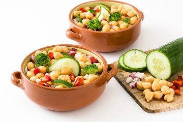 Chickpea salad in brown bowl isolated on white background

