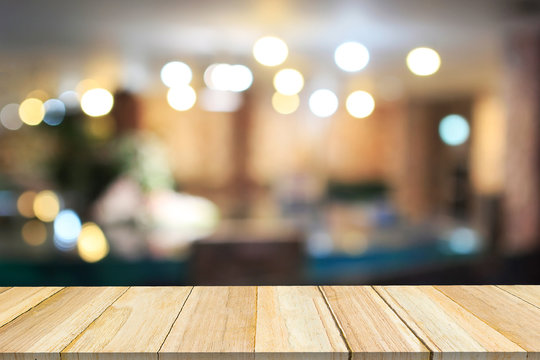 Perspective wood and blurred cafe with bokeh light background.
