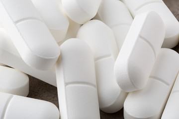 Heap of antibiotic white pills. Closeup