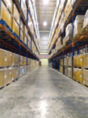 logistic, storage, shipment, industry and manufacturing concept - cargo boxes storing at warehouse shelves bokeh