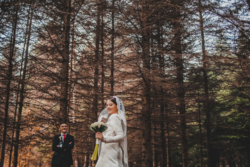Fototapeta premium Young happy newlywed couple, groom and bride together on warm autumn day. Wedding.