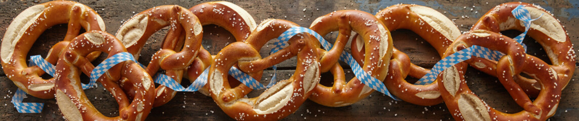 Panoramic banner of salted Bavarian pretzels - obrazy, fototapety, plakaty