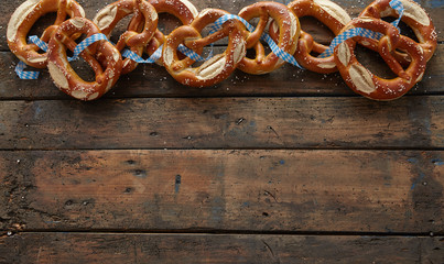 Border of traditional German pretzels on wood