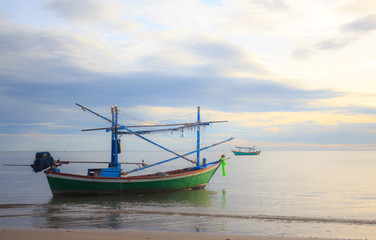 Fototapeta premium fishing boat floating in a sand sea with sunrise