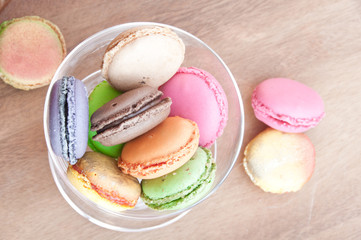 Colorful french sweets macarons on wooden table