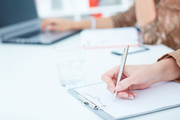 Business woman making notes at office workplace. Business job offer, financial success, certified public accountant concept.