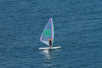 Man on board with sail for surfing