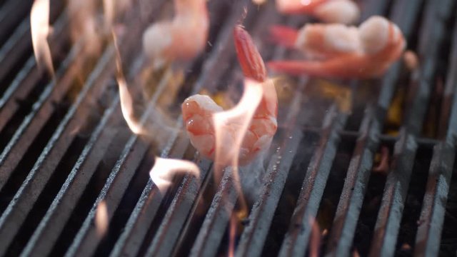 Shrimp falling onto grill in slow motion, shot on Phantom Flex 4K